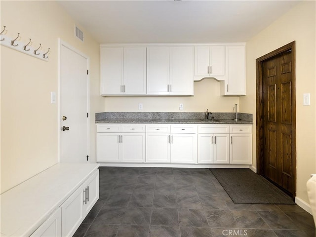 kitchen featuring sink and white cabinets