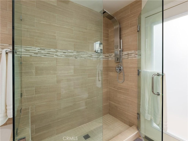 bathroom with a shower with shower door