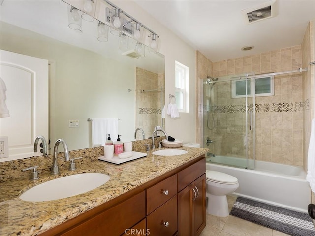 full bathroom featuring tile patterned flooring, enclosed tub / shower combo, vanity, and toilet