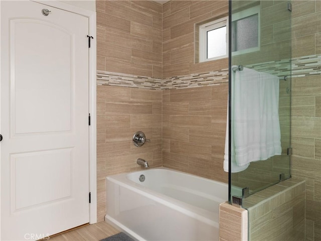 bathroom featuring hardwood / wood-style flooring and shower with separate bathtub