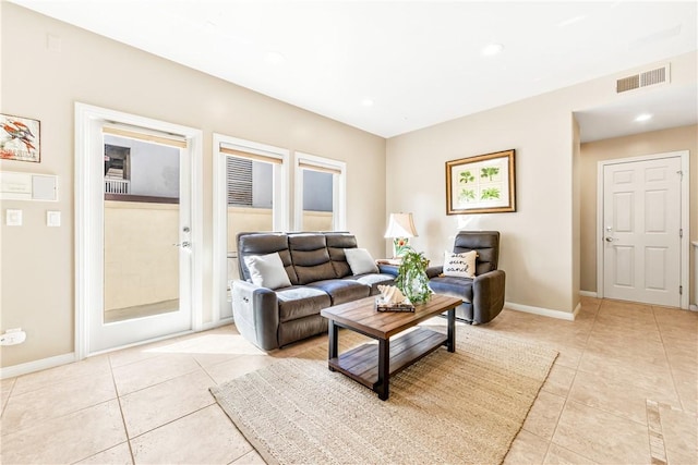 living area featuring light tile patterned floors, baseboards, visible vents, and recessed lighting