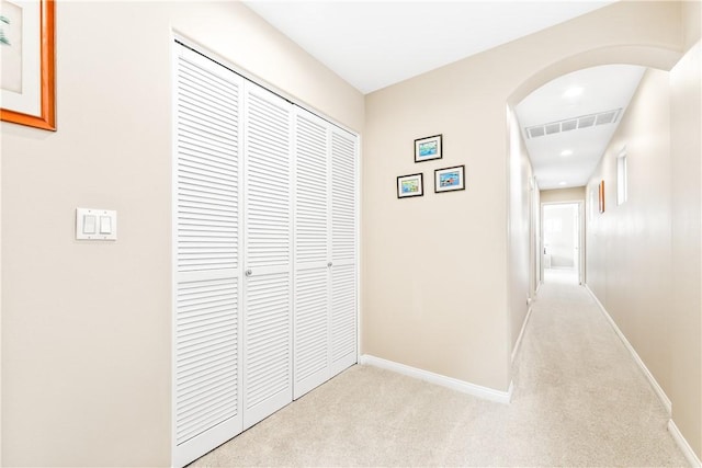 hallway with light colored carpet