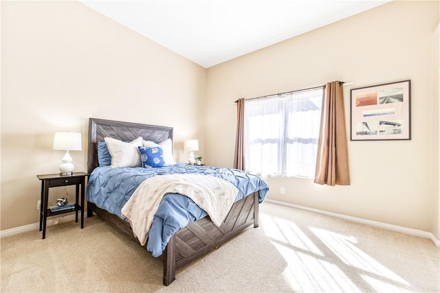 carpeted bedroom with vaulted ceiling