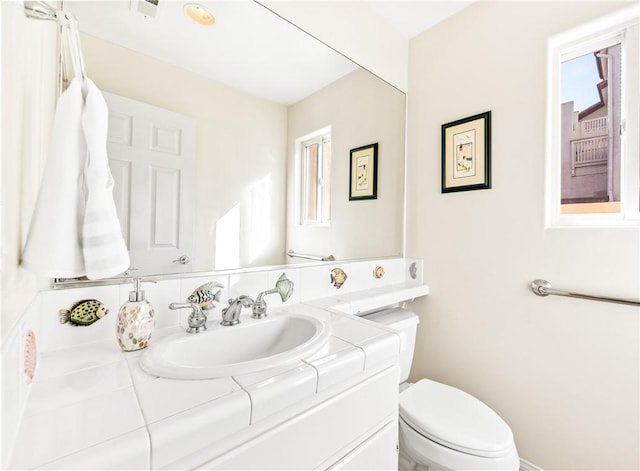 bathroom with toilet and vanity