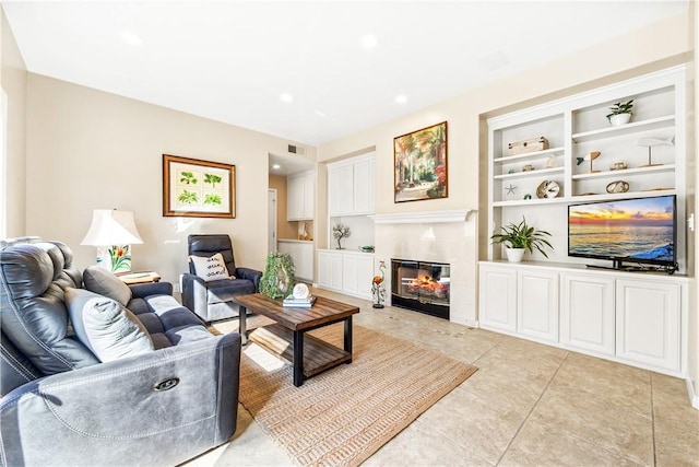 living room featuring built in shelves and light tile patterned flooring