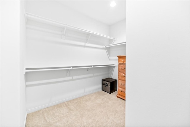 walk in closet with carpet