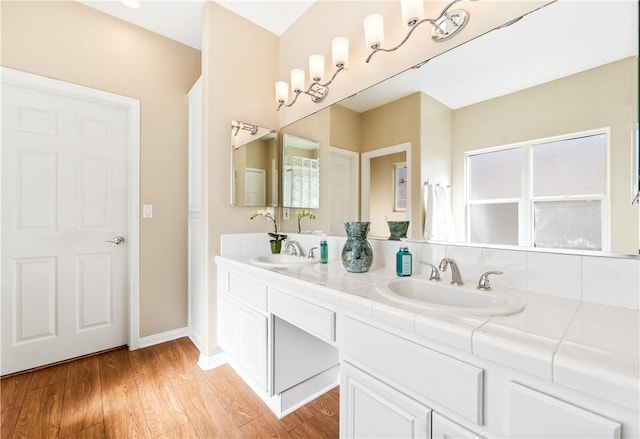 bathroom featuring a healthy amount of sunlight, hardwood / wood-style flooring, and vanity