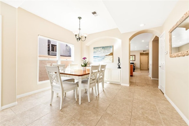 dining area featuring light tile patterned floors, visible vents, arched walkways, a notable chandelier, and recessed lighting