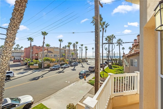 view of road with sidewalks, street lighting, a residential view, and curbs