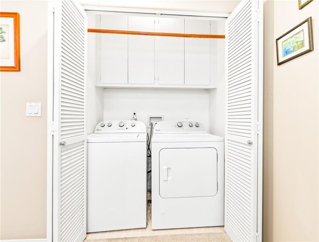 laundry area with cabinet space and separate washer and dryer