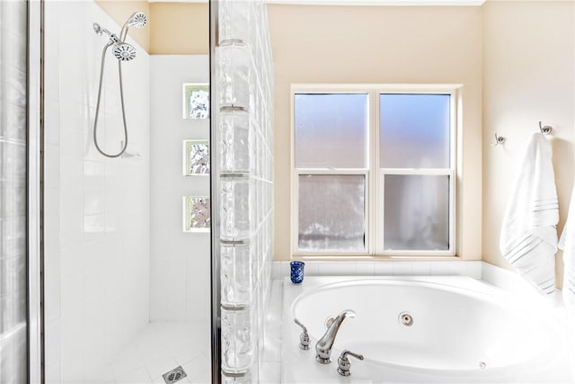 bathroom with a stall shower and a jetted tub