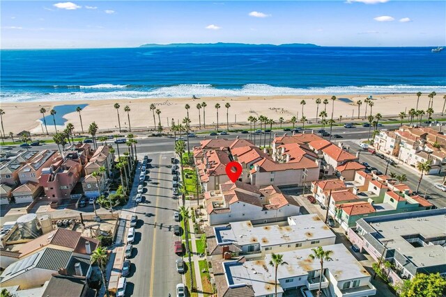 bird's eye view featuring a water view and a beach view