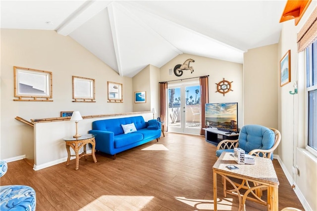 living room featuring vaulted ceiling with beams and hardwood / wood-style floors