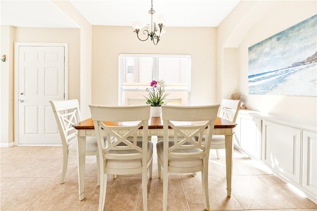 dining room featuring a chandelier and light tile patterned floors