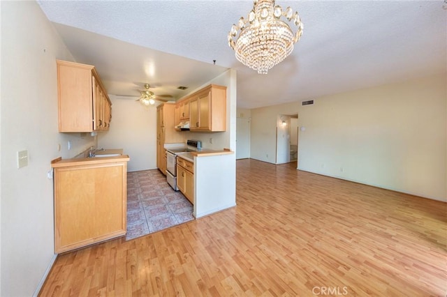 kitchen with light brown cabinetry, white range with electric stovetop, sink, decorative light fixtures, and light hardwood / wood-style floors