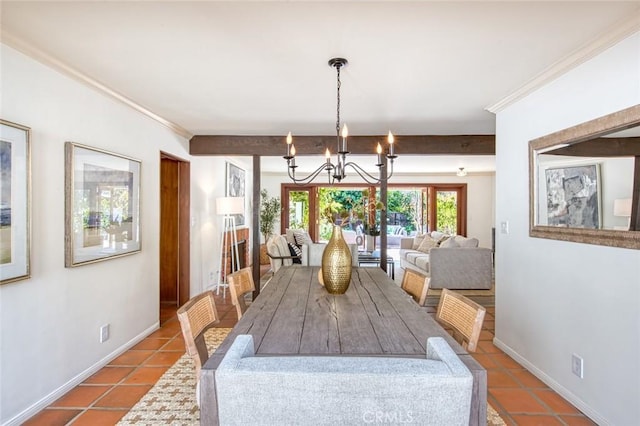 tiled dining space featuring a chandelier and crown molding