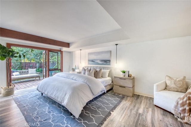 bedroom featuring access to exterior and wood-type flooring