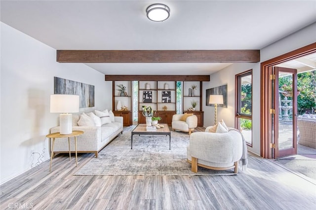 living room with beam ceiling and light wood-type flooring