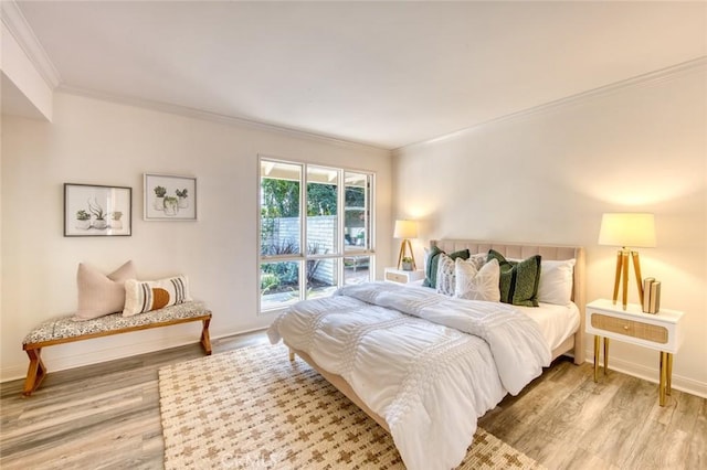 bedroom with light wood-type flooring and ornamental molding