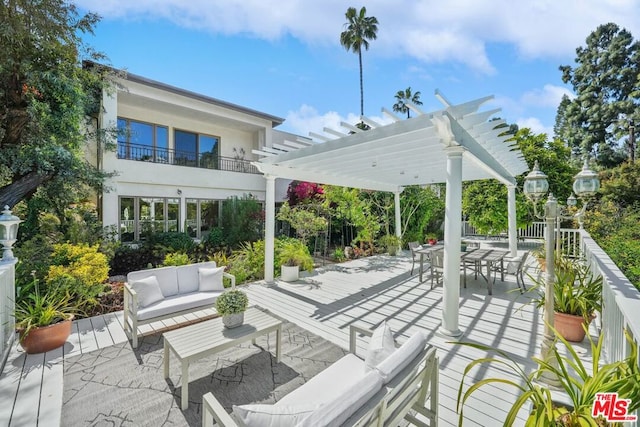 view of patio / terrace featuring a balcony, outdoor lounge area, and a pergola