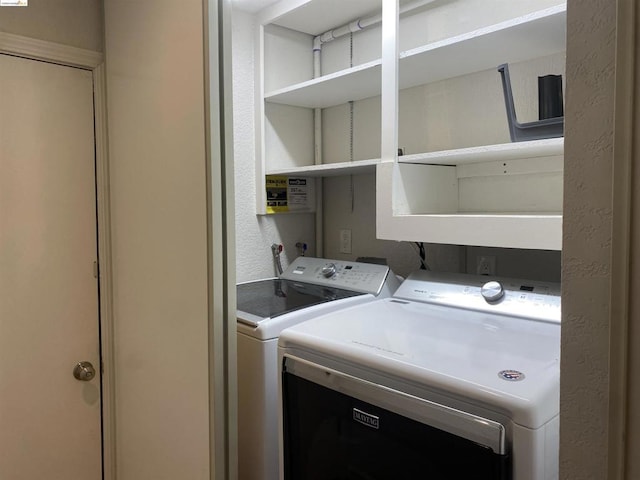 clothes washing area featuring washer and clothes dryer