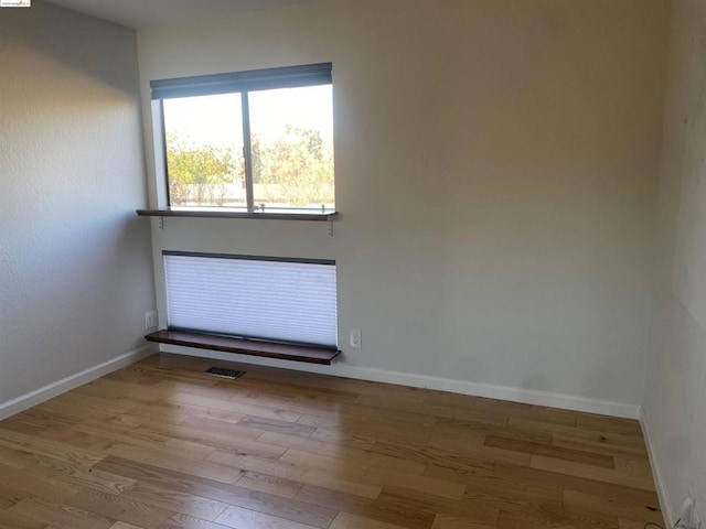 spare room with light hardwood / wood-style floors