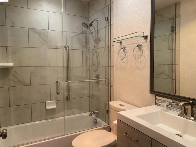 full bathroom with vanity, enclosed tub / shower combo, and toilet