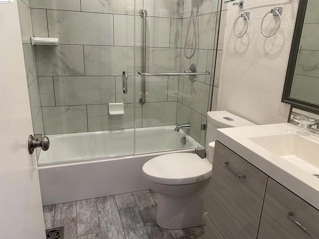 full bathroom featuring vanity, toilet, and enclosed tub / shower combo