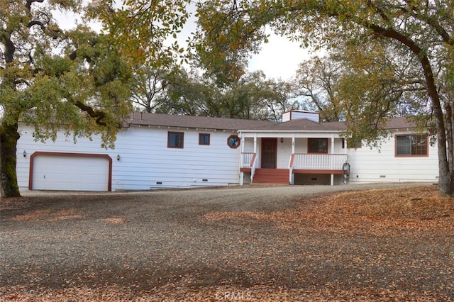 ranch-style home featuring a porch and a garage