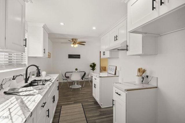 kitchen featuring ceiling fan, white cabinetry, and light stone counters