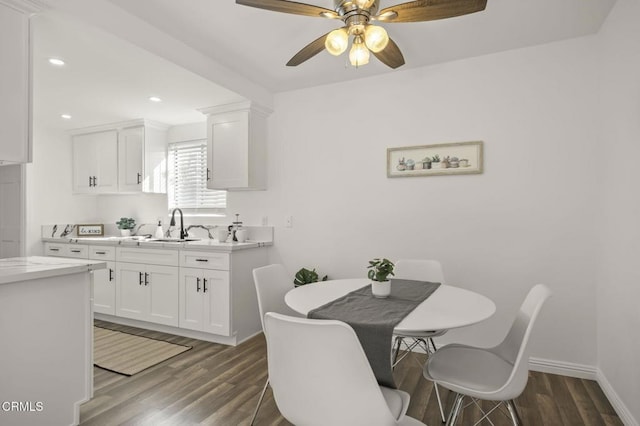 dining area featuring ceiling fan, dark hardwood / wood-style floors, and sink