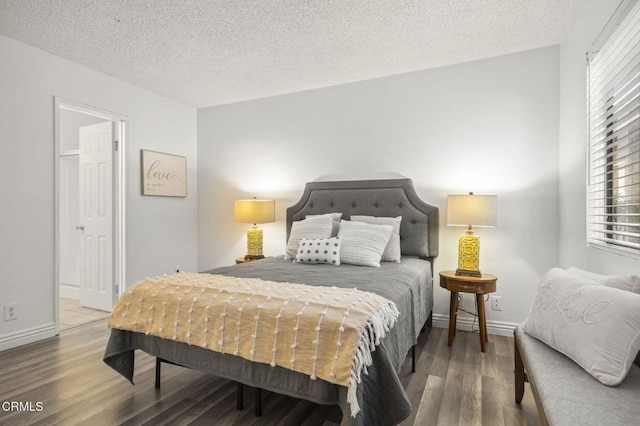 bedroom featuring wood-type flooring and a textured ceiling