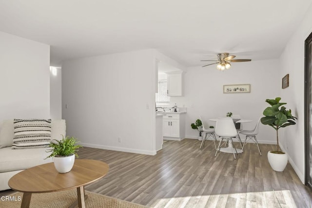 living room featuring ceiling fan and light wood-type flooring