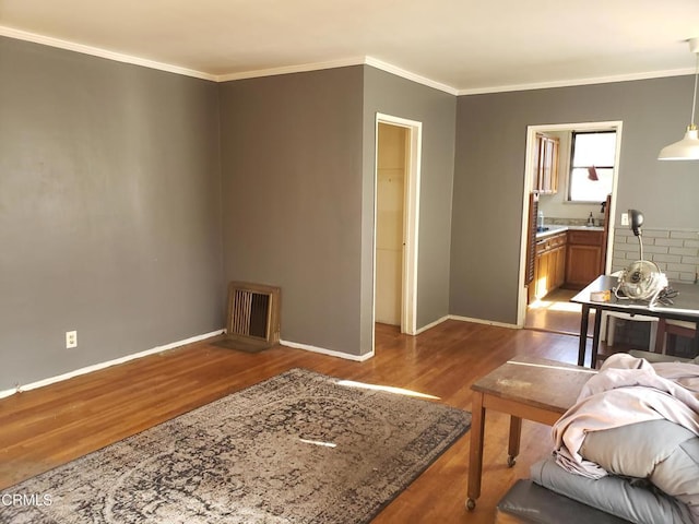 living room with crown molding and hardwood / wood-style floors