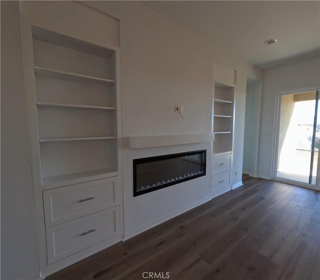 unfurnished living room featuring dark hardwood / wood-style flooring