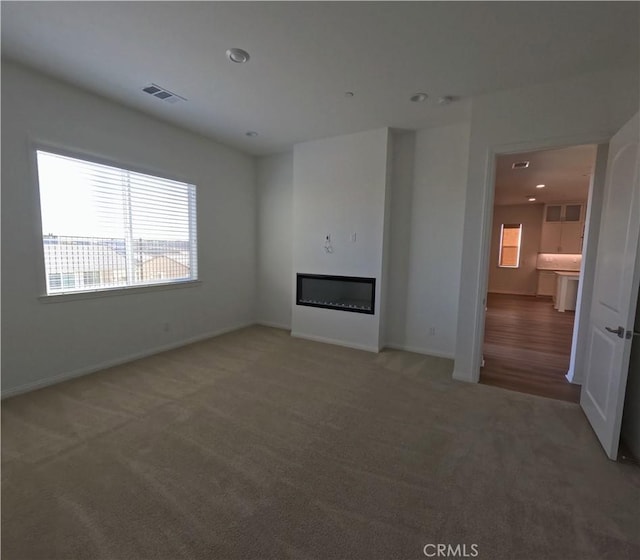 unfurnished living room featuring carpet