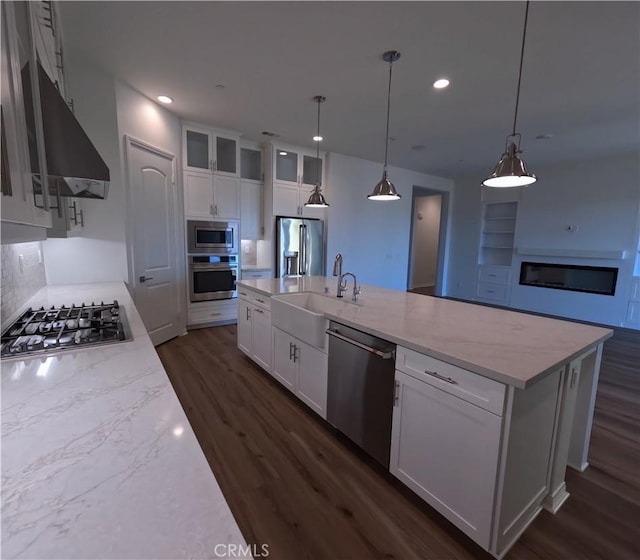 kitchen with stainless steel appliances, dark wood-type flooring, a spacious island, white cabinetry, and hanging light fixtures