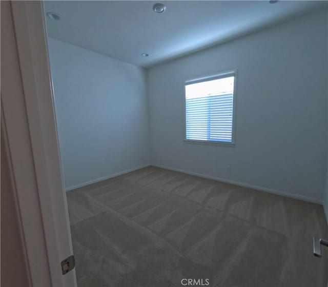 empty room featuring dark colored carpet