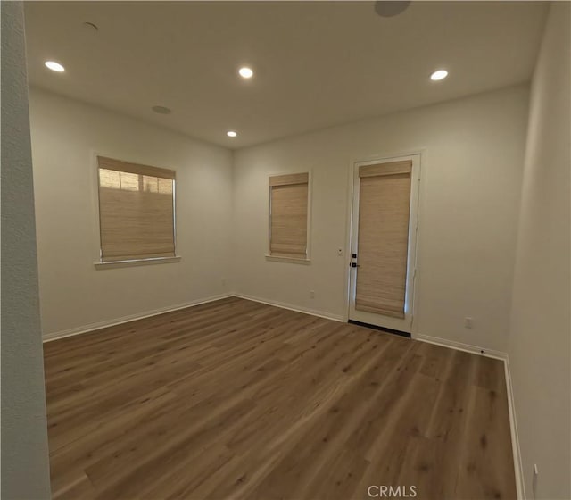 empty room with hardwood / wood-style floors