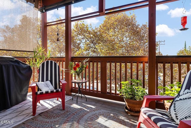 wooden deck featuring a grill