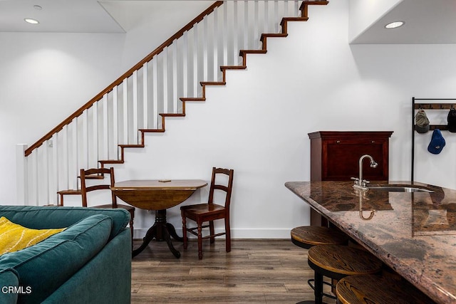 dining room with dark hardwood / wood-style floors and sink