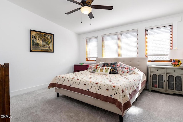 bedroom featuring ceiling fan, light carpet, and lofted ceiling