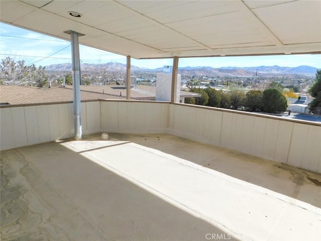 unfurnished sunroom featuring a mountain view