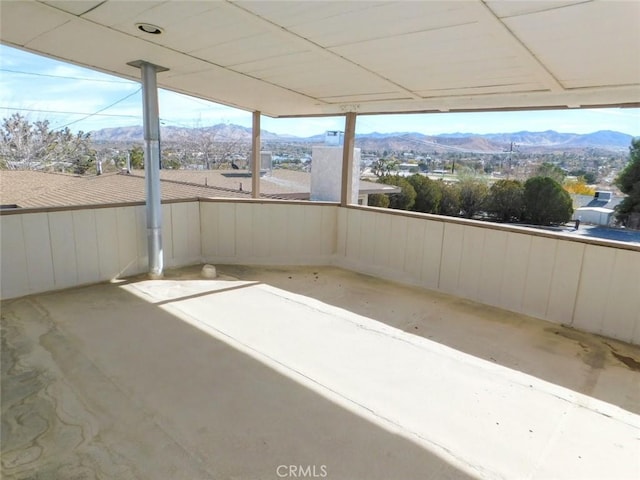 unfurnished sunroom featuring a mountain view