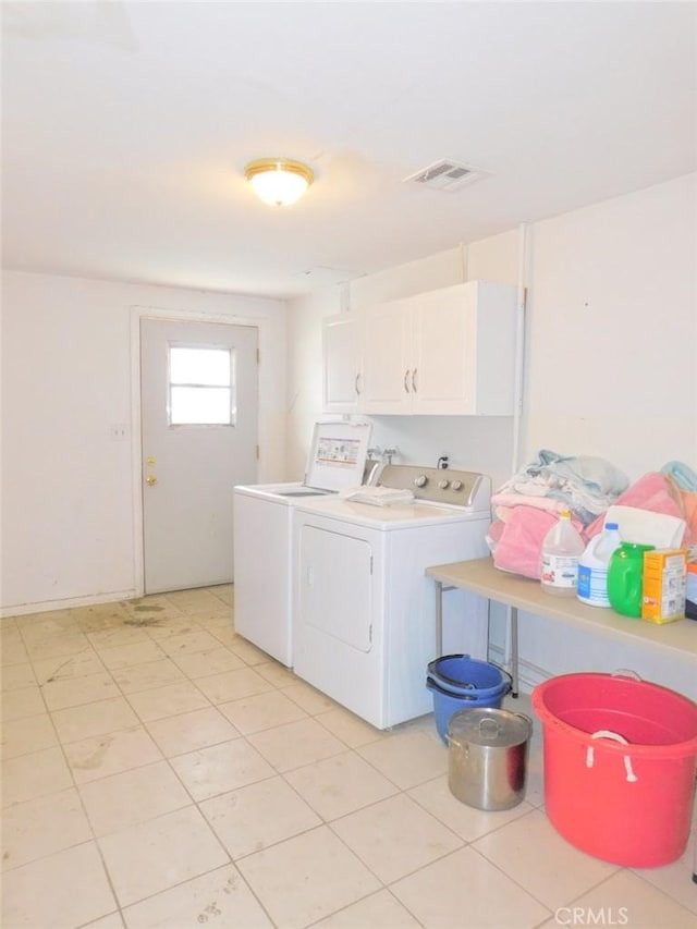 washroom featuring cabinets and washing machine and dryer