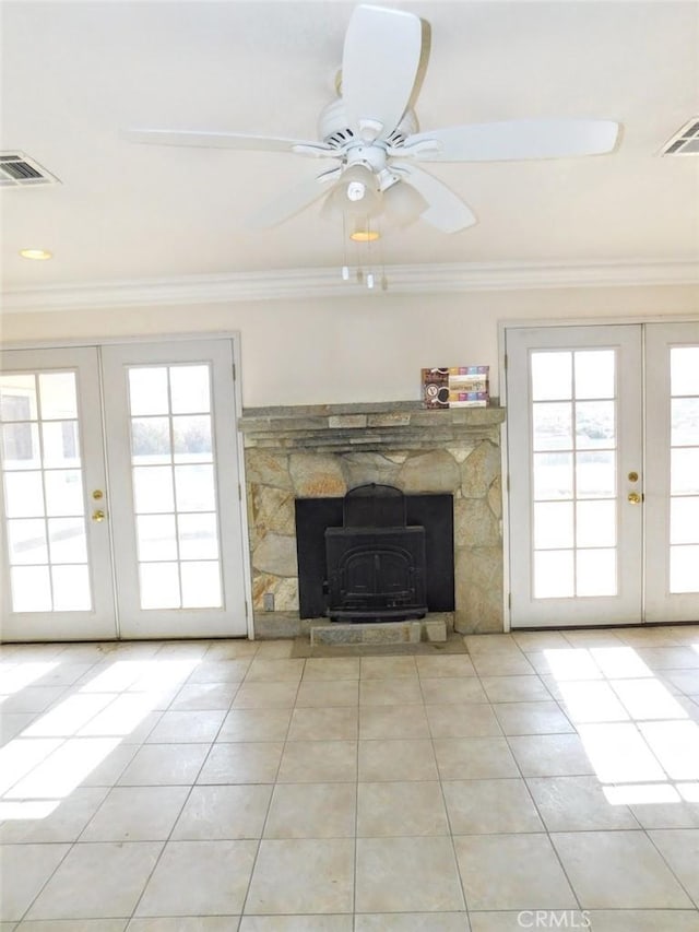 unfurnished living room with french doors, ceiling fan, crown molding, and light tile patterned flooring