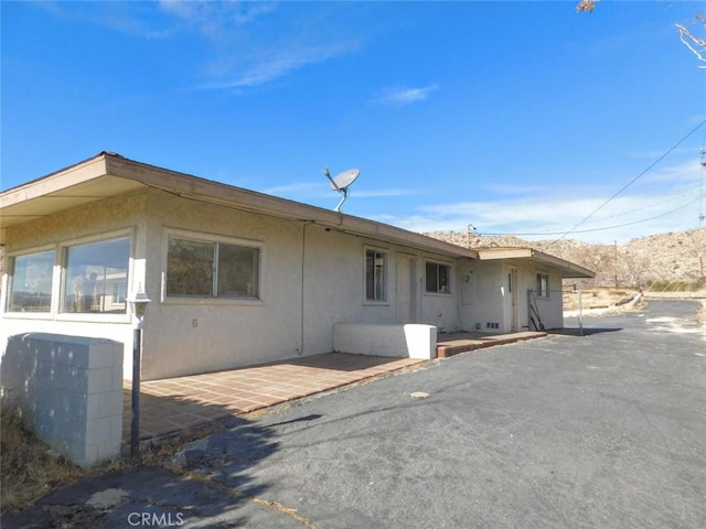 view of side of property with a patio area