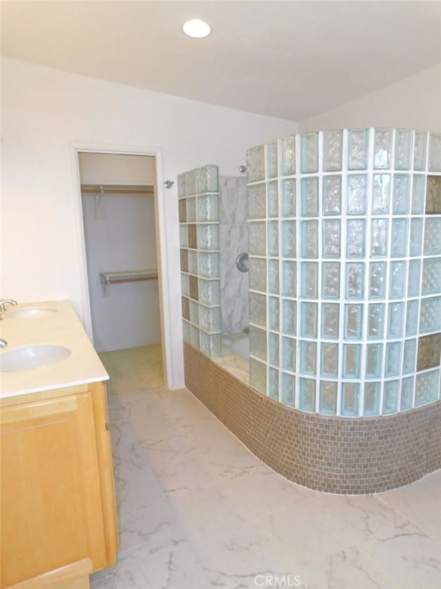 bathroom featuring vanity and a tile shower