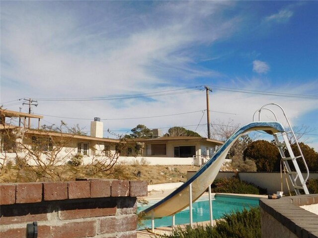 view of pool with a water slide