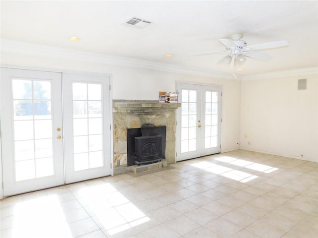 unfurnished living room with french doors, ceiling fan, ornamental molding, and light tile patterned floors